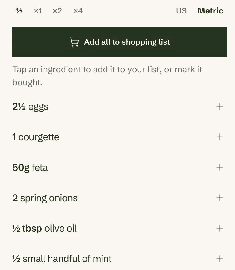 A recipe's ingredient list on a phone with the ½ scale selected, showing 2½ eggs, 1 courgette, 50g feta, 2 spring onions, ½ tbsp olive oil and ½ small handful of mint.